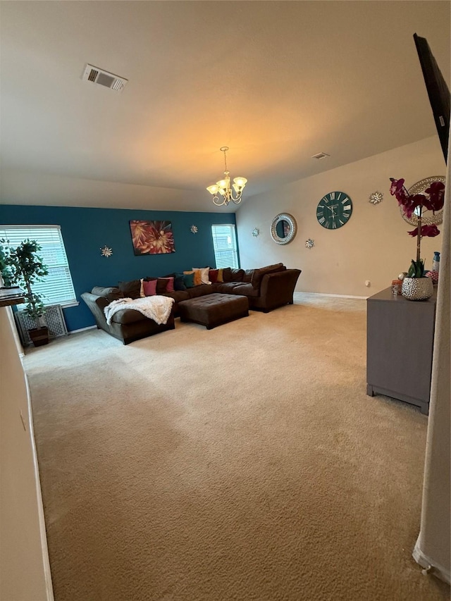 carpeted living room featuring visible vents, a chandelier, and baseboards