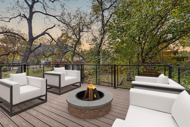 deck featuring an outdoor living space with a fire pit