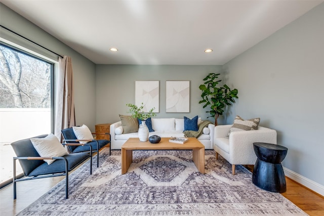 living room with recessed lighting, baseboards, and wood finished floors
