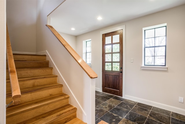 foyer featuring recessed lighting, baseboards, plenty of natural light, and stairs