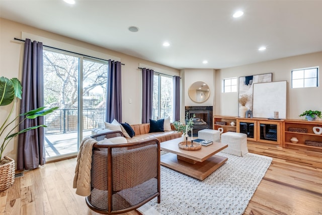 living room with light wood-style floors, a fireplace, and recessed lighting