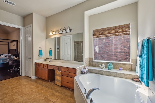 full bath with tile patterned floors, visible vents, vanity, and a bath