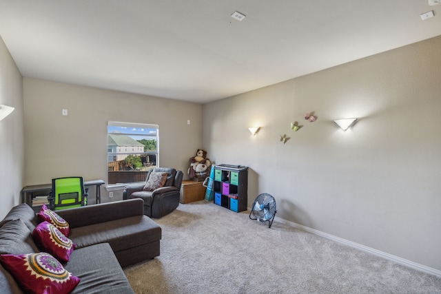 carpeted living area featuring baseboards