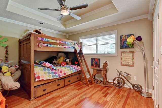 297 Cemetery Rd, Pottsboro, TX 75076 - bedroom featuring baseboards, a raised ceiling, a ceiling fan, crown molding, and light wood-style floors