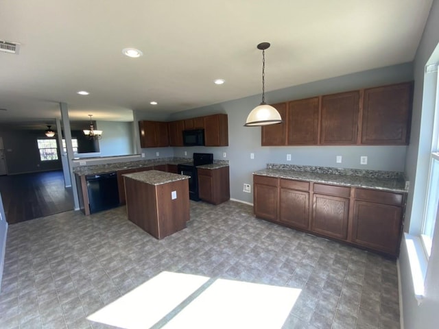 kitchen featuring recessed lighting, a kitchen island, visible vents, hanging light fixtures, and black appliances