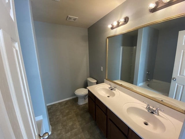 bathroom with a garden tub, double vanity, a sink, and visible vents