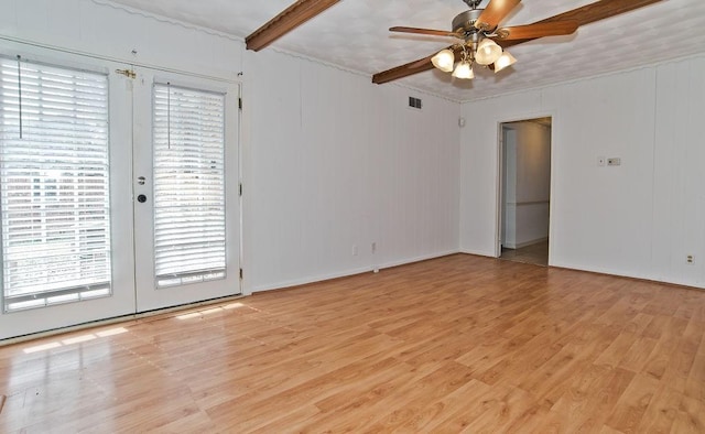 empty room with light wood finished floors, visible vents, a ceiling fan, french doors, and beam ceiling