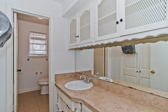 bathroom featuring tile patterned flooring, vanity, and toilet