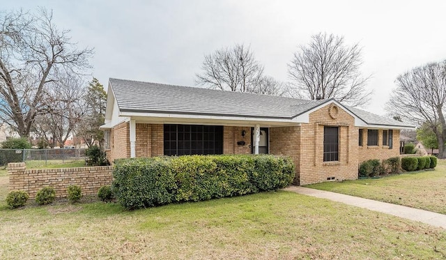 single story home with brick siding, a front lawn, and fence