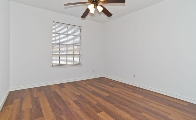 empty room with baseboards, a ceiling fan, and wood finished floors