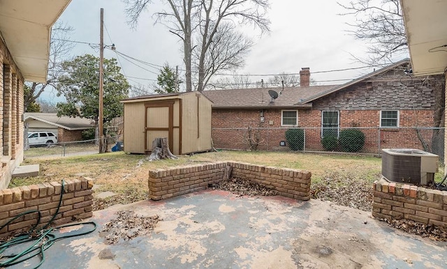 view of patio featuring a storage shed, central AC unit, an outdoor structure, and a fenced backyard