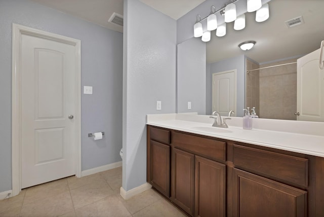 bathroom featuring vanity, tile patterned flooring, visible vents, and baseboards