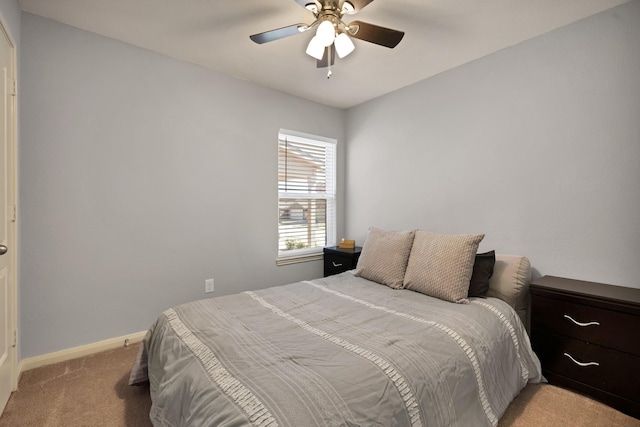 bedroom with carpet floors, a ceiling fan, and baseboards