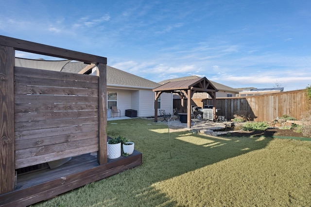 view of yard featuring fence, a gazebo, and a patio