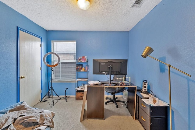 office space featuring baseboards, light colored carpet, visible vents, and a textured ceiling