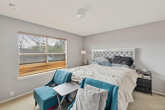 carpeted bedroom with a textured ceiling and baseboards