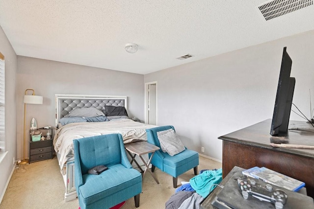 carpeted bedroom with visible vents and a textured ceiling