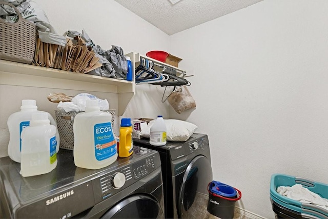 laundry room featuring laundry area, baseboards, washer and clothes dryer, and a textured ceiling