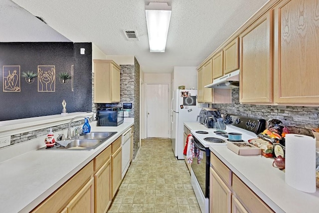 kitchen with white appliances, light brown cabinets, visible vents, and under cabinet range hood