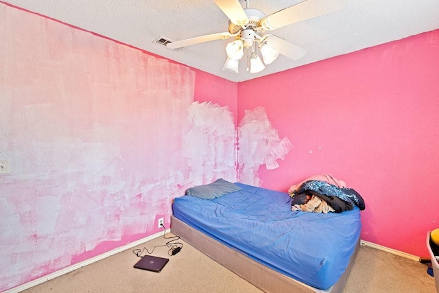 bedroom with carpet, visible vents, ceiling fan, a textured ceiling, and baseboards