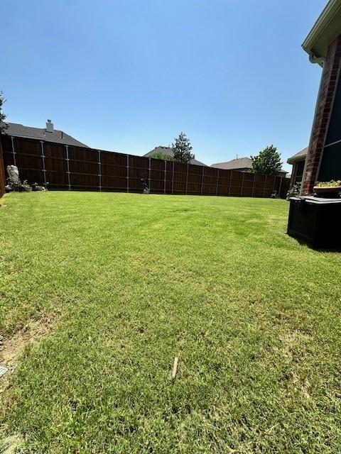 view of yard with a fenced backyard