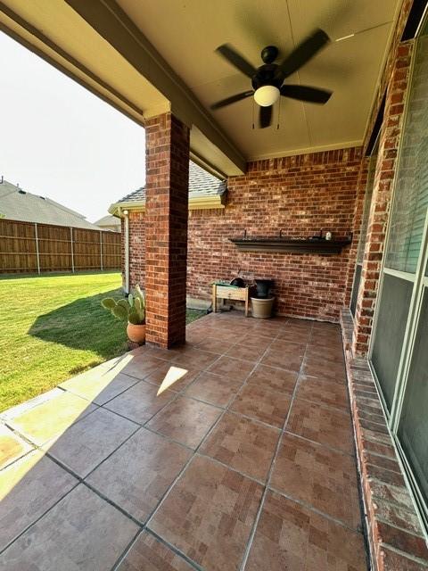 view of patio featuring ceiling fan and fence