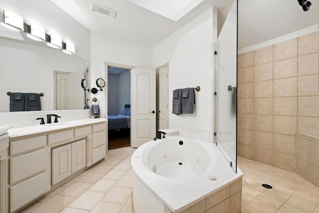 bathroom with visible vents, vanity, tile patterned flooring, a whirlpool tub, and walk in shower