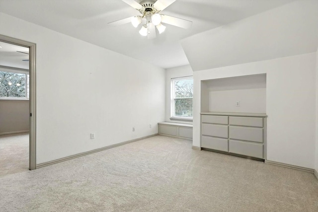 unfurnished bedroom with a ceiling fan and carpet