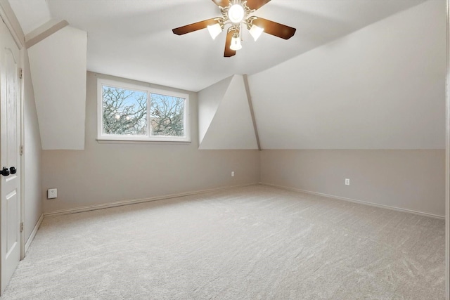 additional living space with vaulted ceiling, carpet, a ceiling fan, and baseboards