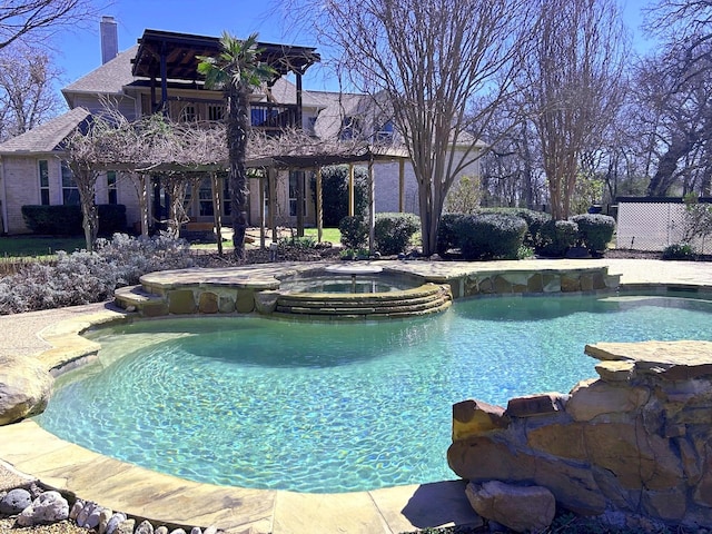 view of pool featuring a pool with connected hot tub