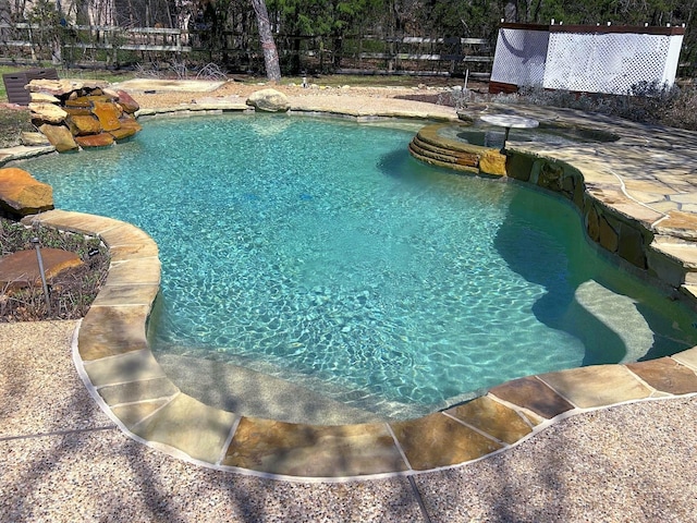 view of swimming pool with a fenced in pool