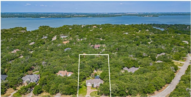 drone / aerial view featuring a water view and a view of trees