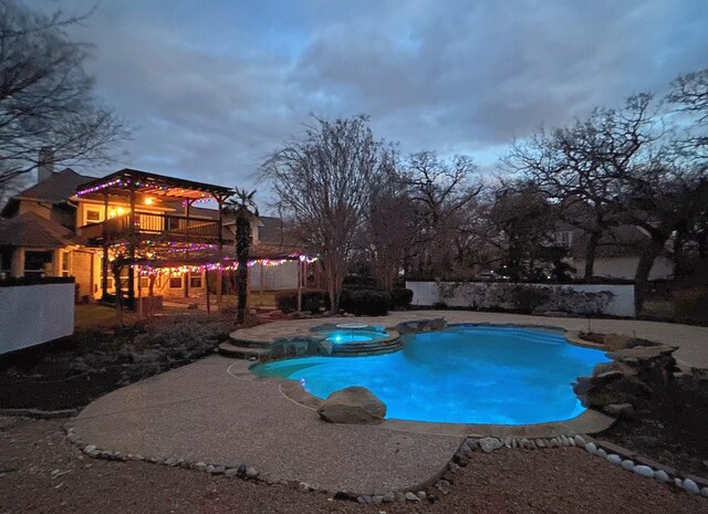 view of swimming pool featuring a pool with connected hot tub and a patio area