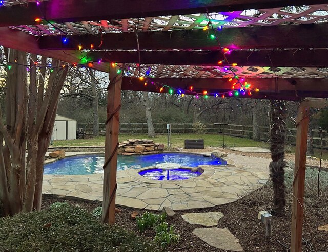 pool featuring a storage shed, an outbuilding, a fenced backyard, and a pergola