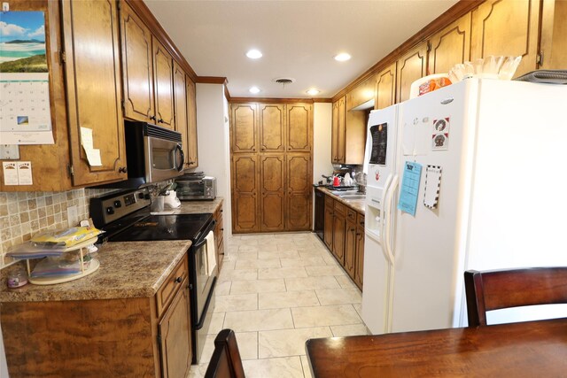 8418 W Wilderness Way, Shreveport, LA 71106 - kitchen featuring brown cabinets, recessed lighting, backsplash, and appliances with stainless steel finishes