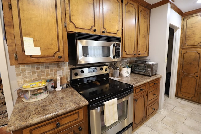 8418 W Wilderness Way, Shreveport, LA 71106 - kitchen featuring tasteful backsplash, crown molding, a toaster, appliances with stainless steel finishes, and brown cabinets
