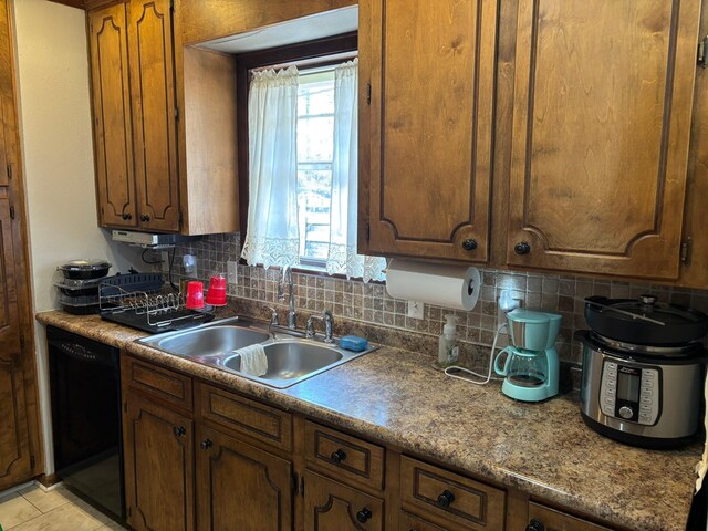 8418 W Wilderness Way, Shreveport, LA 71106 - kitchen with a sink, black dishwasher, brown cabinets, and tasteful backsplash