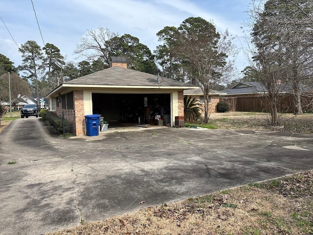 8418 W Wilderness Way, Shreveport, LA 71106 - view of property exterior featuring a chimney, fence, a detached garage, and an outdoor structure