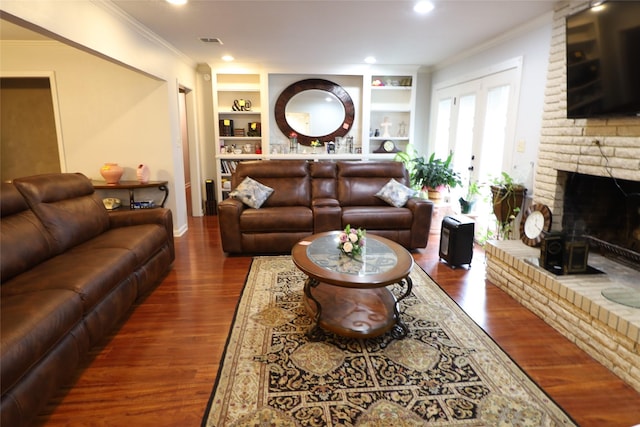 8418 W Wilderness Way, Shreveport, LA 71106 - living room with visible vents, crown molding, a fireplace, built in shelves, and wood finished floors