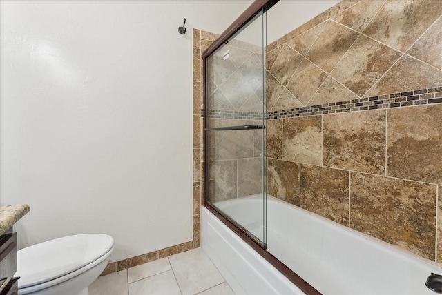 full bathroom featuring tile patterned floors, baseboards, enclosed tub / shower combo, and toilet