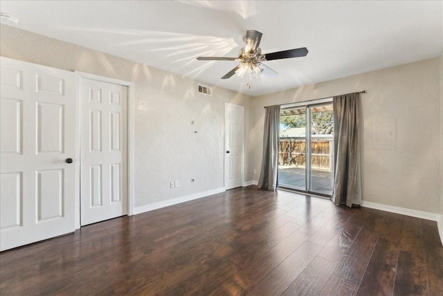 empty room with visible vents, baseboards, and wood finished floors