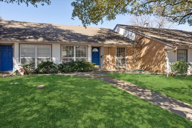 ranch-style house with stucco siding and a front lawn