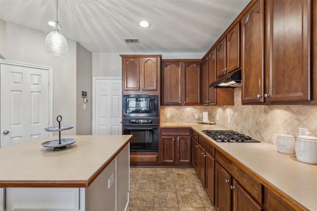 kitchen with light countertops, visible vents, backsplash, under cabinet range hood, and black appliances