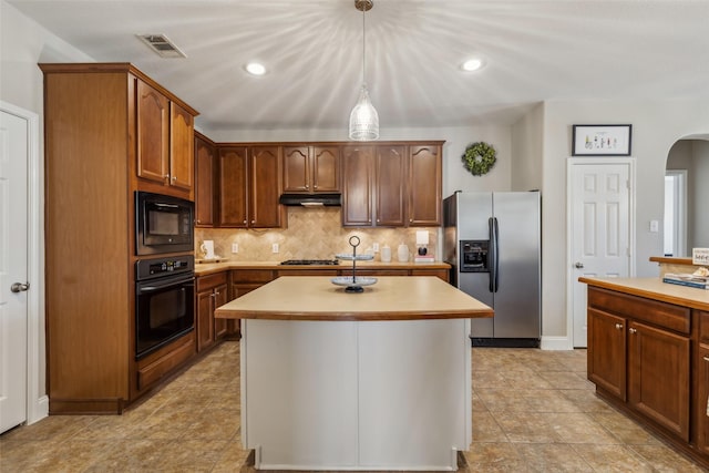 kitchen with arched walkways, visible vents, decorative backsplash, light countertops, and black appliances