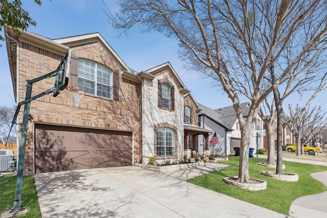 view of front of home featuring a garage, driveway, stone siding, a front lawn, and brick siding