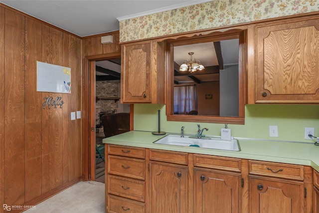 kitchen with brown cabinetry, light countertops, and a sink