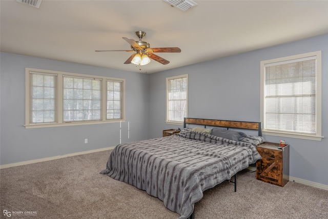 bedroom with carpet floors, baseboards, visible vents, and ceiling fan