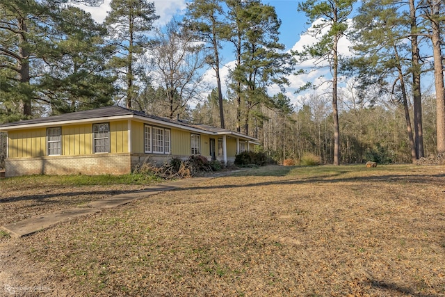 view of home's exterior featuring a yard and brick siding