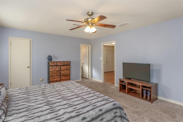 carpeted bedroom with a ceiling fan, visible vents, and baseboards