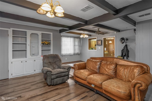 living area with beam ceiling, visible vents, a notable chandelier, and wood finished floors